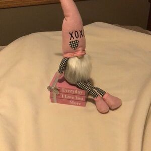 Pink and black gnome and little wooden fake book stack